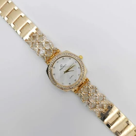 ساعت مچی زنانه مجلسی ریلانس Riluns نگین‌دار با موتور کوارتز (بند طلایی صفحه سفید)