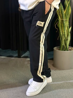 شلوار جاگر نیم بگ مشکی با دیزاین نوار خطی کنفی سفید اورجینال دیلم