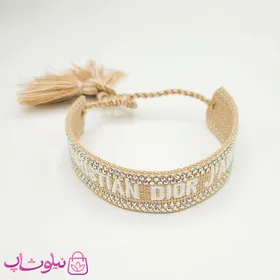 دستبند دخترانه پارچه ای کریستن دیور مدل کرم نگین‌دار