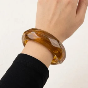 دستبند زنانه بنگل رزینی مدل امبریا کهربایی موج‌دار