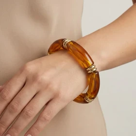 دستبند زنانه بنگل رزینی چندتکه مدل امبریا طلایی‑کهربایی