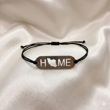 دستبند استیل مدل «HOME - ایران» | بند بافت مشکی با پلاک نقره‌ای