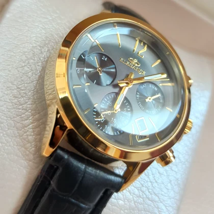 ساعت چرمی زنانه الگانس طرح سه موتور تقویم دار بند مشکی صفحه طوسی