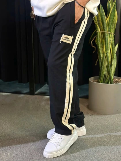 شلوار جاگر نیم بگ مشکی با دیزاین نوار خطی کنفی سفید اورجینال دیلم