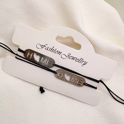 دستبند استیل مدل «HOME - ایران» | بند بافت مشکی با پلاک نقره‌ای