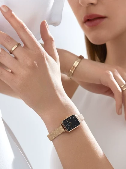 ساعت دنیل ولینگتون حصیری زنانه رزگلد صفحه مستطیل مشکی Daniel Wellington Rosegold